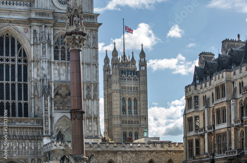 London, UK - September 16, 2022:  Westminster Abbey, Parliament tower with British flag during funeral ceremony of Queen Elizabeth II photo
