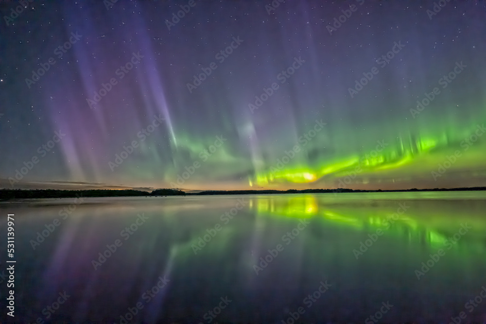 Northern lights dancing over calm lake in norrth of sweden. Northern lights dancing over calm lake in norrth of sweden.