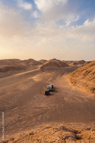 Three campers in the middle of the desert at sunset. The Kalut desert in Iran is the hottest point on the planet. © JoseMaria