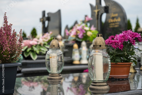 Decoration, candles and flowers on the tombs in cemetery.