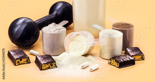 food supplements, whey, creatine, casein and whey, dumbbells, protein bar and pills for muscle mass gain