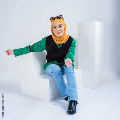 Portrait of a beautiful female Muslim model wearing hijab, a lifestyle apparel for Muslim women isolated on white background. Modern hijab fashion concept.