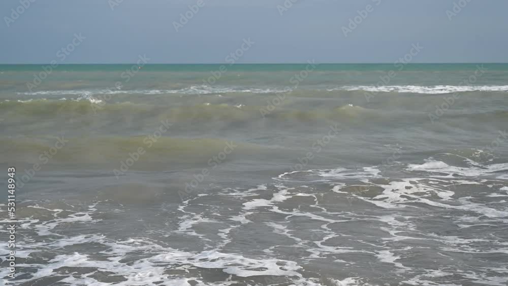 Adriatic sea, Lido di Jesolo, Italy. Sea waves. Foamy waves at sandy beach in summer. Adriatic sea, Lido di Jesolo, Italy. Sea waves. Foamy waves at sandy beach in summer.