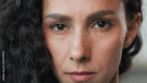 Portrait sad woman face female model posing indoors upset anxiety frustrated worried about breakup divorce. Arabian hispanic depressed girl victim of domestic violence serious look at camera close up photo