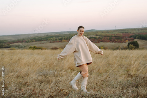 Stylish woman enjoying autumn weather outdoor. Fashion, style concept. People, lifestyle, relaxation and vacations concept.