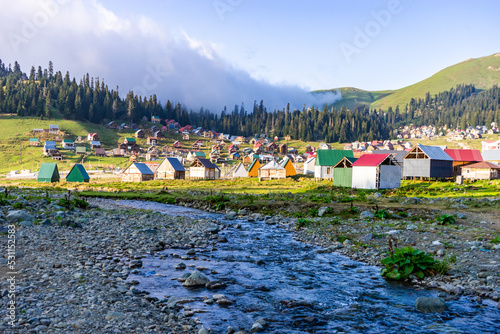 Traditional village houses  in the Caucasus mountains by a river, Bakhmaro, Chokhatauri, Guria, Georgia photo