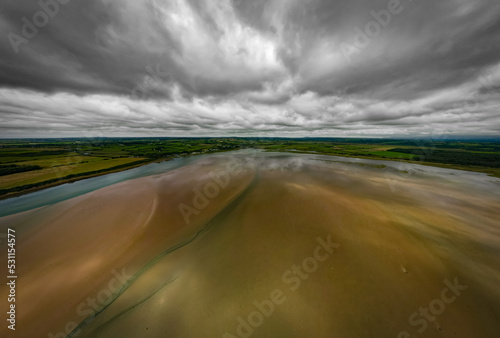 Clouds over the Cefni Estuary and the village of Malltraeth, Anglesey, Wales. Aerial view