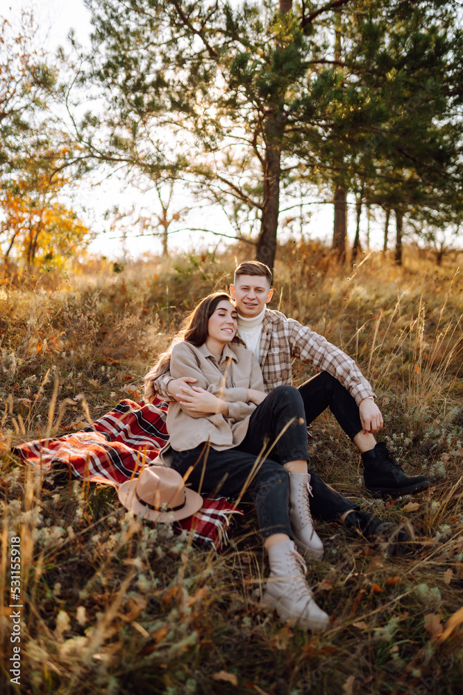 Young couple in love walking in the park on a autumn day. Enjoying time together. Young couple in love walking in the park on a autumn day. Enjoying time together.