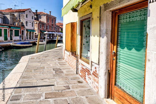 Fototapeta Naklejka Na Ścianę i Meble -  Murano, Italy - July 7, 2022: Scenery along the canals in Murano Italy
