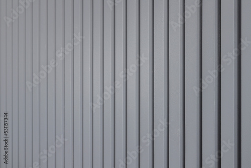 Gray vertical wooden panels close-up on the wall
