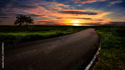 Dramatic landscape at sunset with empty highway.