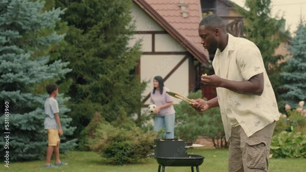 An African dad cooks krill vegetables for his multi-ethnic family.Multiracial Family,Mixed Race,Diverse People,Multiethnic Relations An African dad cooks krill vegetables for his multi-ethnic family.Multiracial Family,Mixed Race,Diverse People,Multiethnic Relations