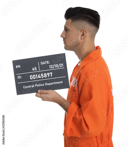 Foto Mug shot of prisoner in orange jumpsuit with board on white background, side vie