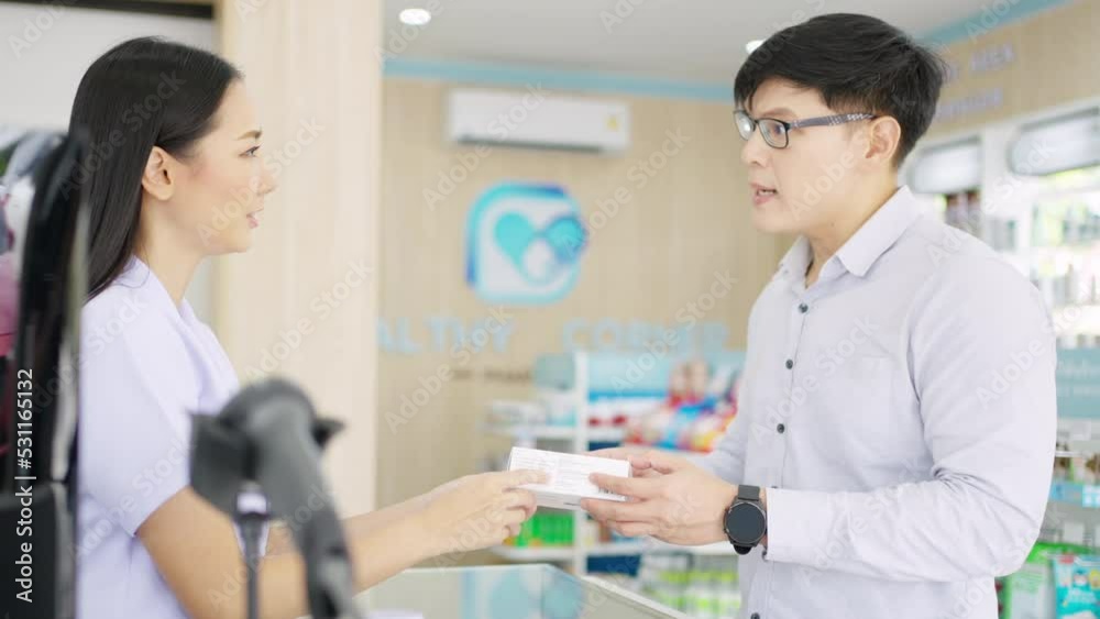 4K Attractive Asian woman pharmacist medication recommendation about medicine, drugs and supplements to male patient customer in modern drugstore. Medical pharmacy and healthcare providers concept. 4K Attractive Asian woman pharmacist medication recommendation about medicine, drugs and supplements to male patient customer in modern drugstore. Medical pharmacy and healthcare providers concept.