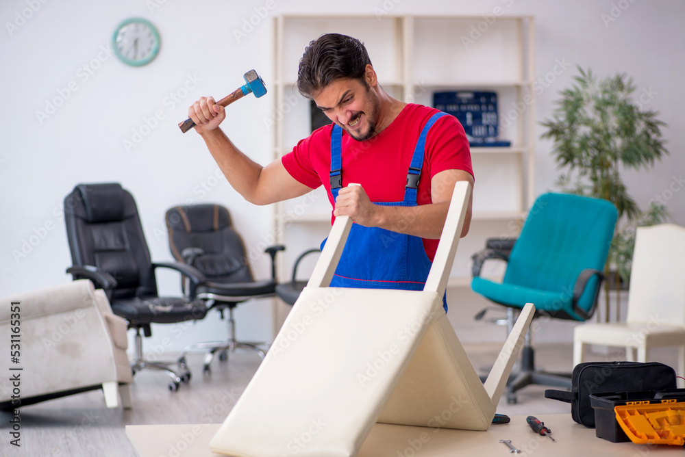 © Elnur - Young male carpenter working at workshop
