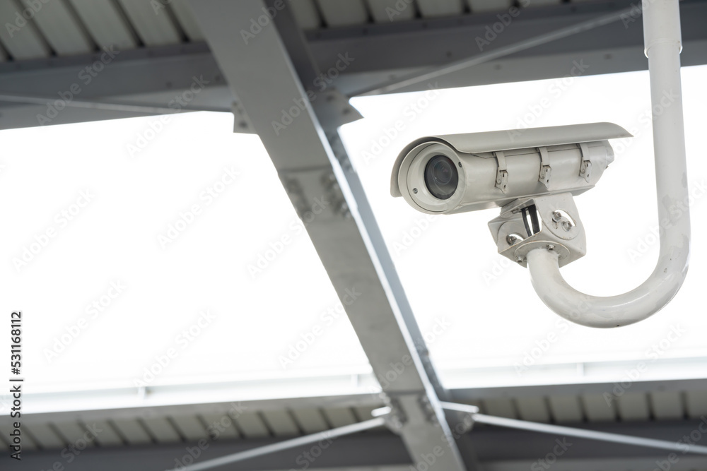 CCTV surveillance security camera video equipment on pole outdoor building safety system area control and copy space. Smart camera theft protection.