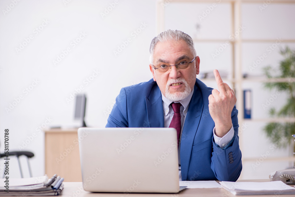 Old male employee and too much work in the office Old male employee and too much work in the office