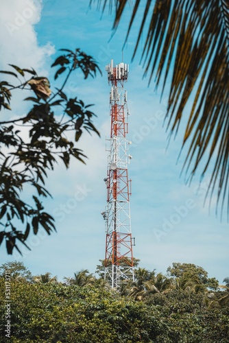 Celullar tower in distance on a sunny day photo