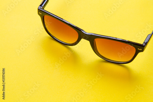 Sunglasses on yellow background; eye protection concept