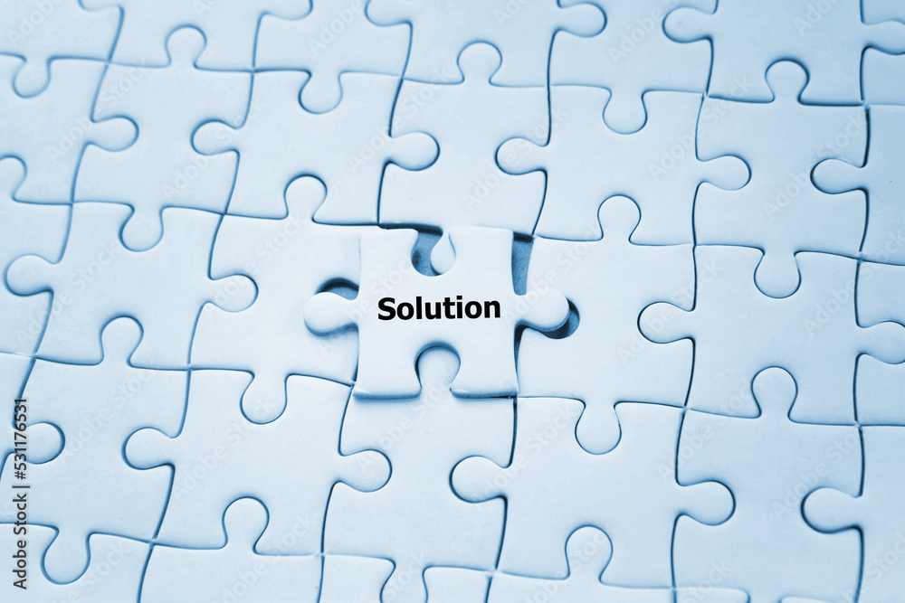 Business solution on jigsaw puzzle; solving problem concept Business solution on jigsaw puzzle; solving problem concept