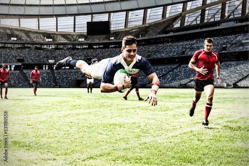 Digital composite image of rugby player jumping with the ball in sports stadium © vectorfusionart