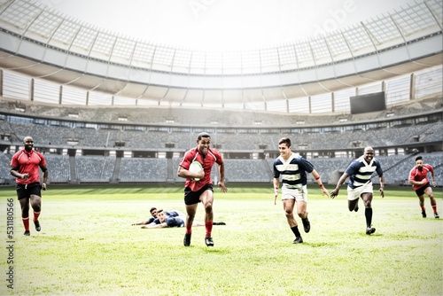 Digital composite image of team of rugby players playing rugby in sports stadium © vectorfusionart