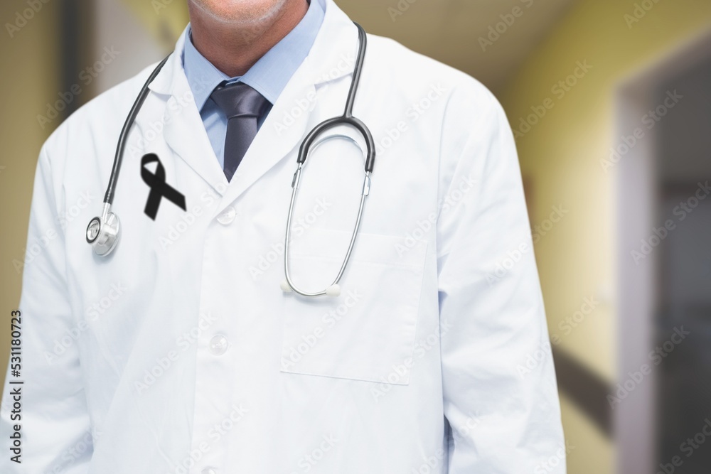 Mid section of male doctor with black ribbon on robe standing in the hospital Mid section of male doctor with black ribbon on robe standing in the hospital