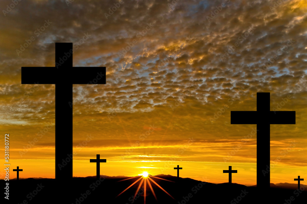 The cross has a backdrop of sunrise.
