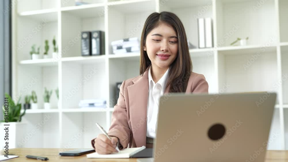 Attractive Asian Business Woman Discussing Sales Report in Online Meeting Notebook Video Conferencing in Office Work Attractive Asian Business Woman Discussing Sales Report in Online Meeting Notebook Video Conferencing in Office Work
