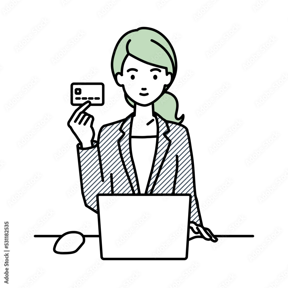 デスクで座ってPCを使いながらクレジットカードを手に持っているスーツの女性 デスクで座ってPCを使いながらクレジットカードを手に持っているスーツの女性