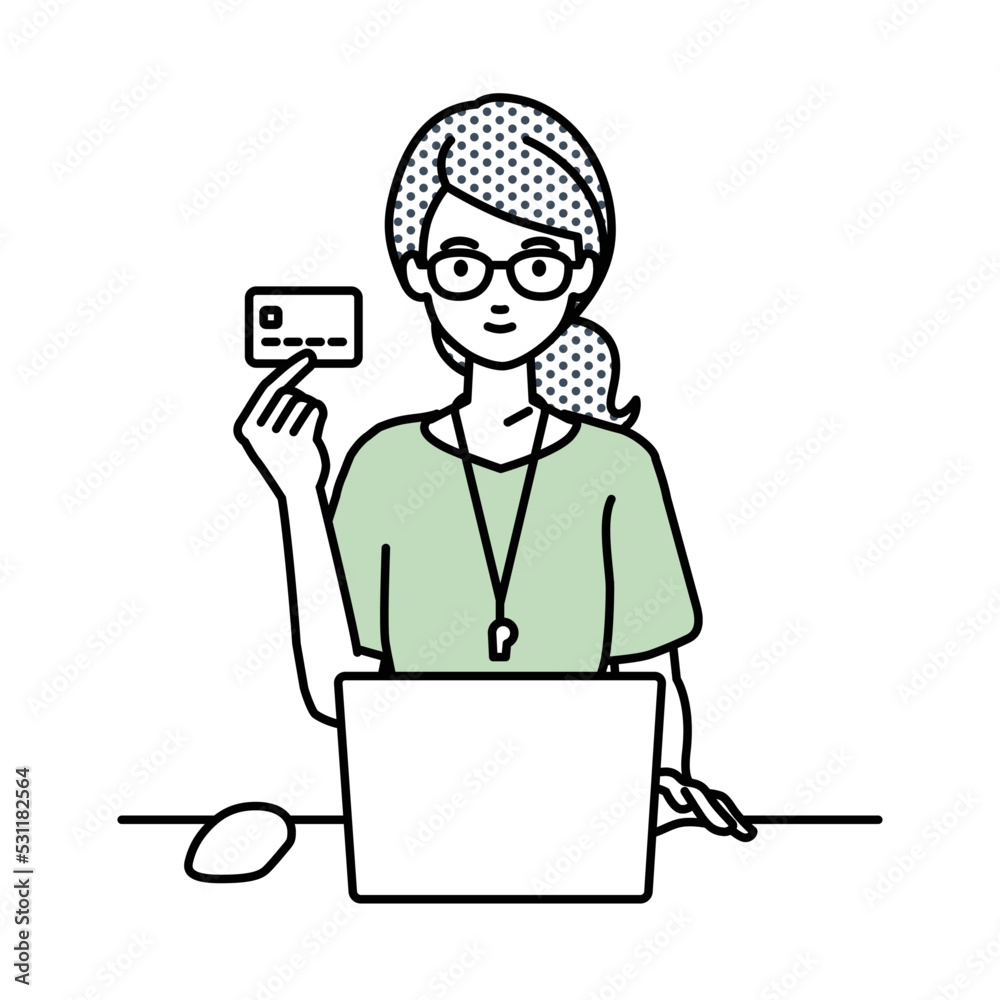 デスクで座ってPCを使いながらクレジットカードを手に持っている教師の女性