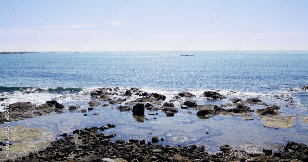 Stone rock sea beach with sunny sky