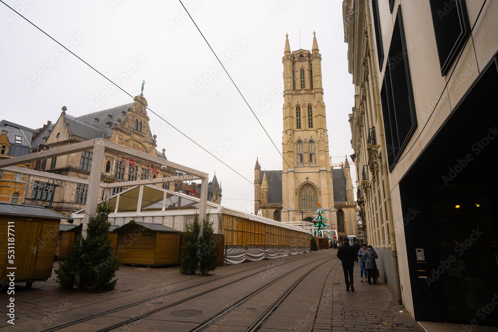 Saint Bavo's Cathedral , and Sint Baafsplein . Beautiful church and square in Ghent during winter cloudy day : Ghent , Belgium : November 30 , 2019