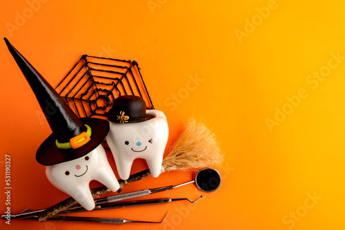 dentistry.dental.halloween. holiday concept. holidays. dentist.character for dentist halloween card.dental concept. figurines of teeth in halloween costumes and dental instruments. pumpkins and broom