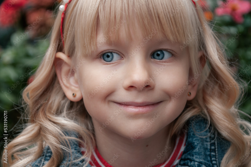 Portrait of a girl with blond hair with a wound on her chin. Joyful child. Portrait of a girl with blond hair with a wound on her chin. Joyful child.