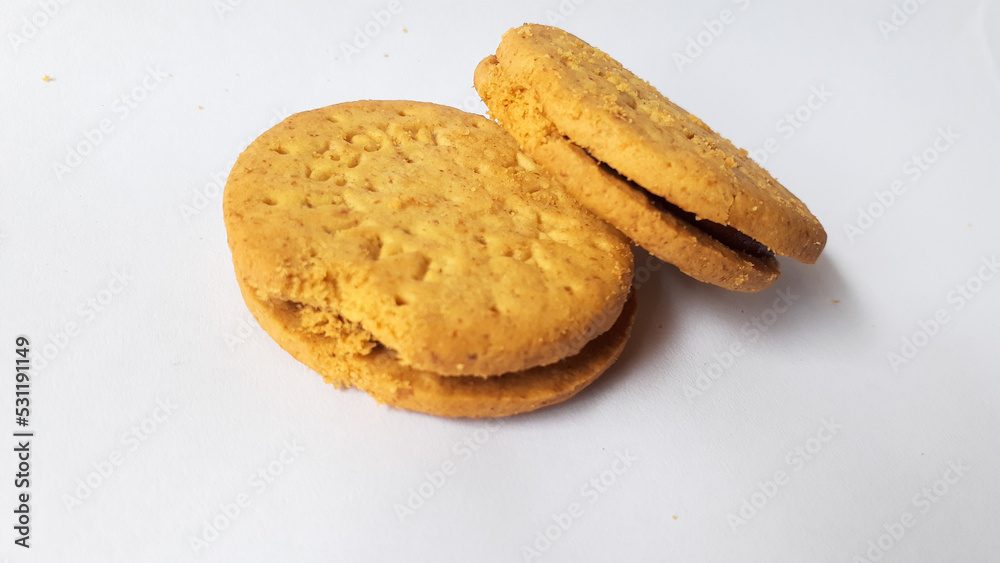 BISCUITS - Delicious wheat round biscuits with a few crumbs isolated on white BISCUITS - Delicious wheat round biscuits with a few crumbs isolated on white