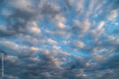 White cumulus clouds on a clear blue sky. © lms_lms