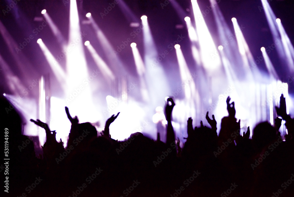 Rear view of crowd with arms outstretched at concert Rear view of crowd with arms outstretched at concert