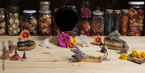 Meditation Altar With Rock Crystals and Flowers. Jars of Herbs in Background