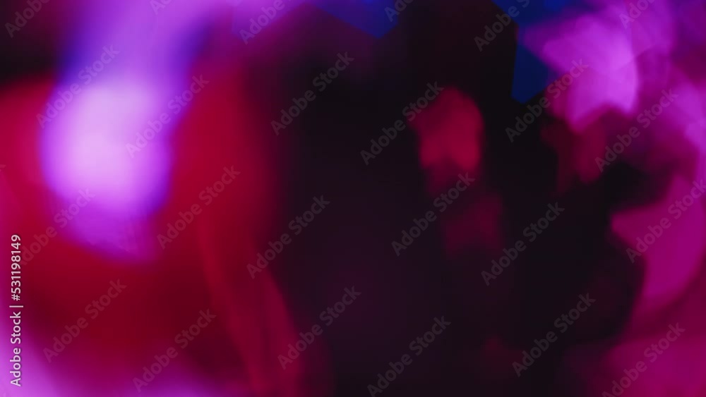 Color bokeh glow. Light flare overlay. Star pattern radiance. Defocused neon pink blue red gleam motion on dark black abstract background.