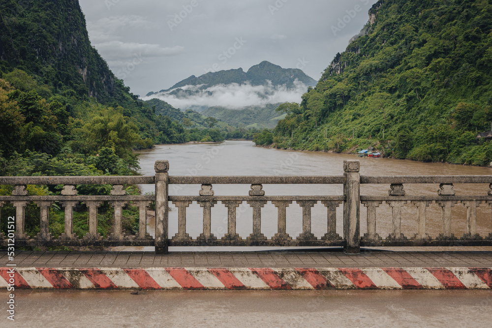View from the bridge in Nong Khiaw, Laos over the Nam Ou River and the valley in the background