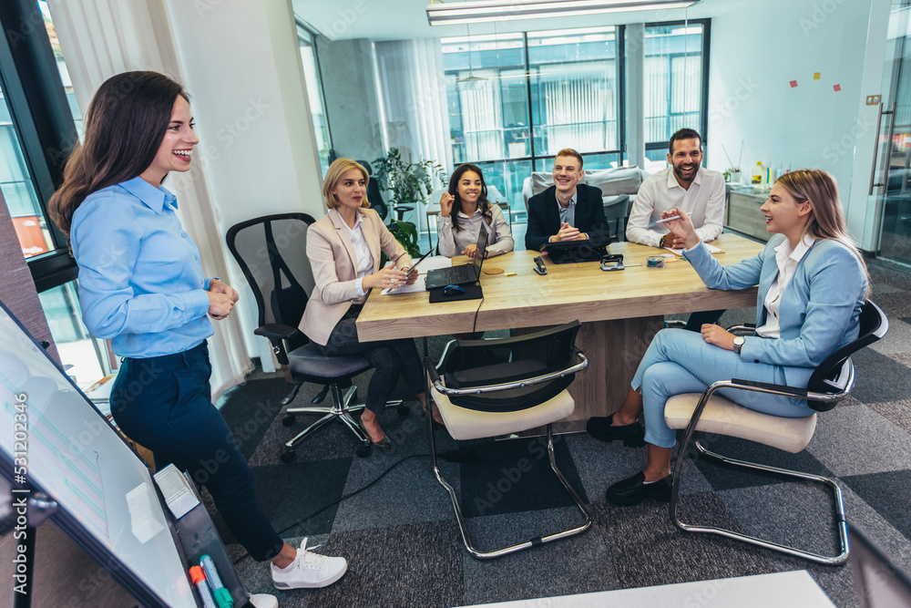 Shot of a businesswoman giving a presentation to her colleagues on a whiteboard in a boardroom