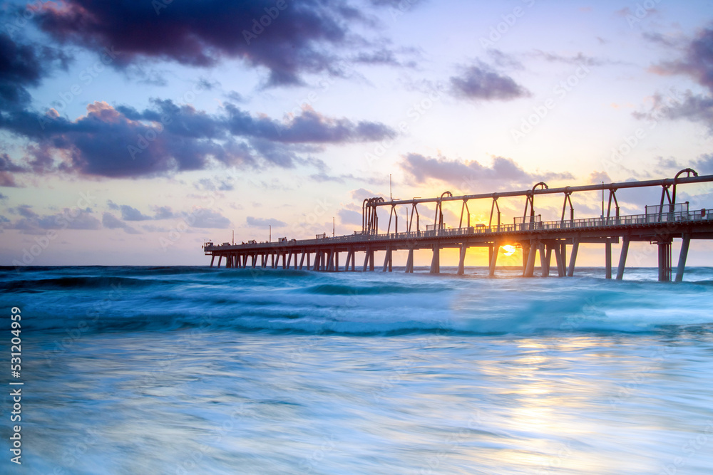 Sunrise through the pier at The Spit in the Gold Coast Sunrise through the pier at The Spit in the Gold Coast