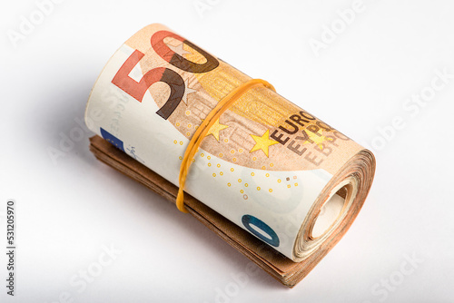 Roll of money. Roll of 50 euro banknotes. Euro banknotes rolled up on a gray background. The concept of financial assistance, real estate purchase, loan or insurance payment.