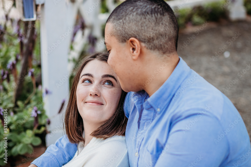 smiling lgbtqi couple looking at one another smiling lgbtqi couple looking at one another
