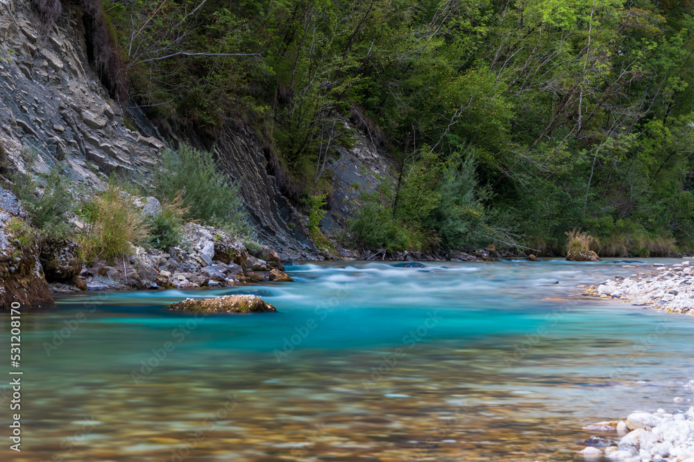 Colorful long exposure picture of emerald Soa (also known as Isonzo) River Valley at Julian Alps in Bovec, Slovenia