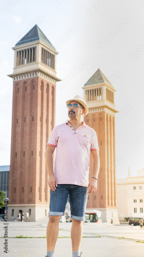 Attractive man posing next to the Venetian towers in Montjuic, Barcelona (Spain).