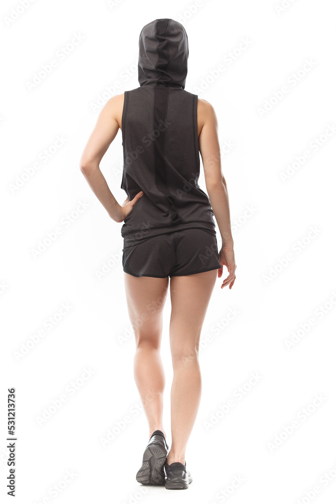 Fototapeta premium Athletic girl in gray clothes for sports and fitness on a isolated white background.