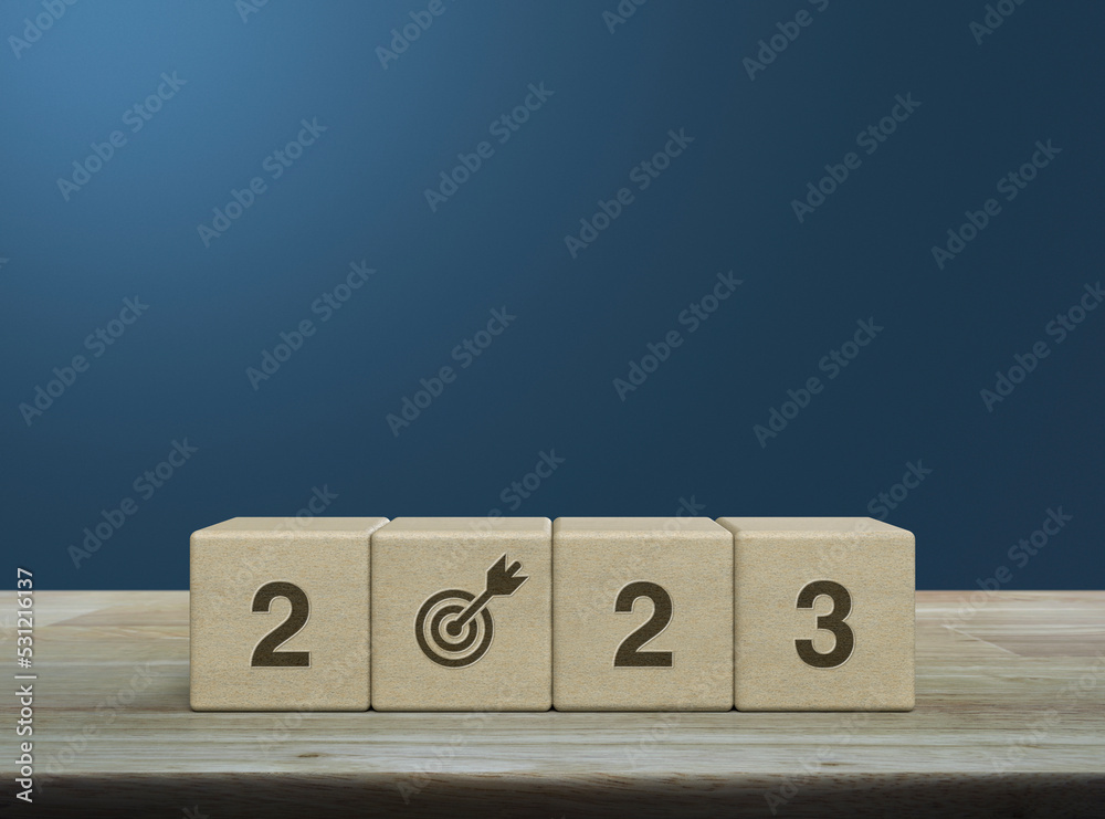2023 letter with goal icon on wood block cubes on wooden table over light blue wall, Happy new year 2023 success concept 2023 letter with goal icon on wood block cubes on wooden table over light blue wall, Happy new year 2023 success concept