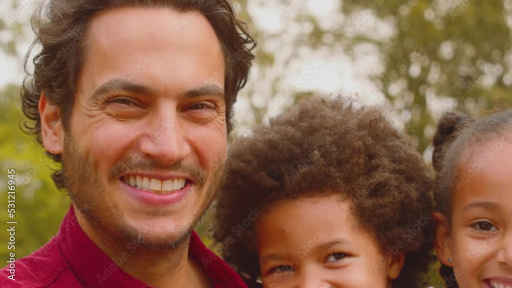 Camera tracks across faces of smiling multi-racial family walking in summer countryside - shot in slow motion Camera tracks across faces of smiling multi-racial family walking in summer countryside - shot in slow motion